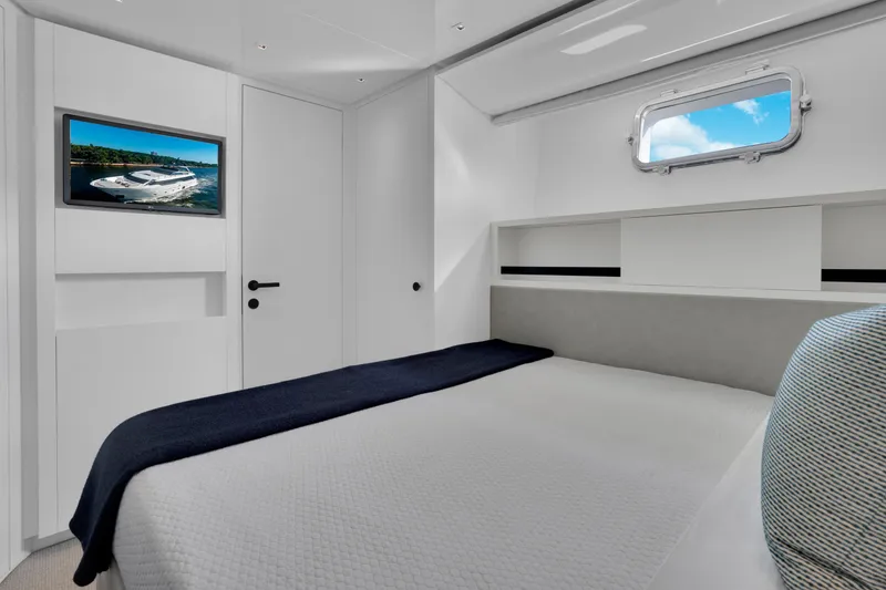 Slide: The Image of Luxurious 2023 Sanlorenzo SL96A yacht bedroom with modern decor and window view. - 27