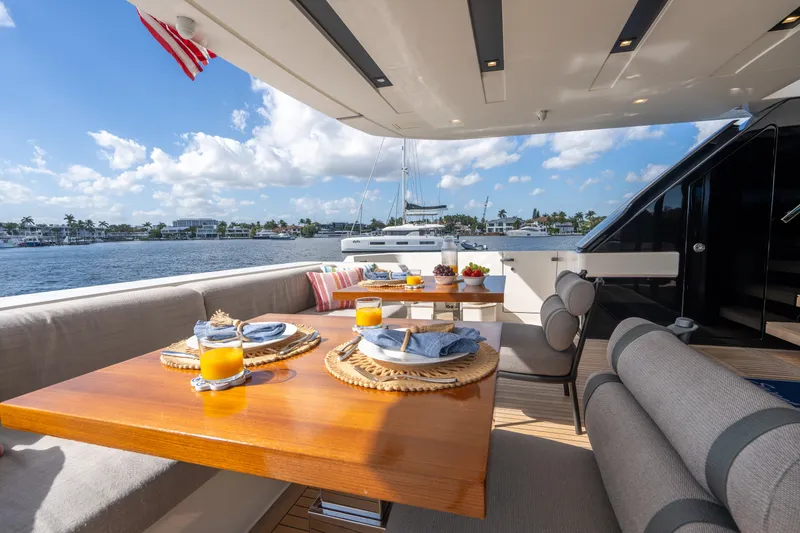 Slide: The Image of Luxurious 2023 Sanlorenzo SL96A yacht deck with elegant dining setup and ocean view. - 41