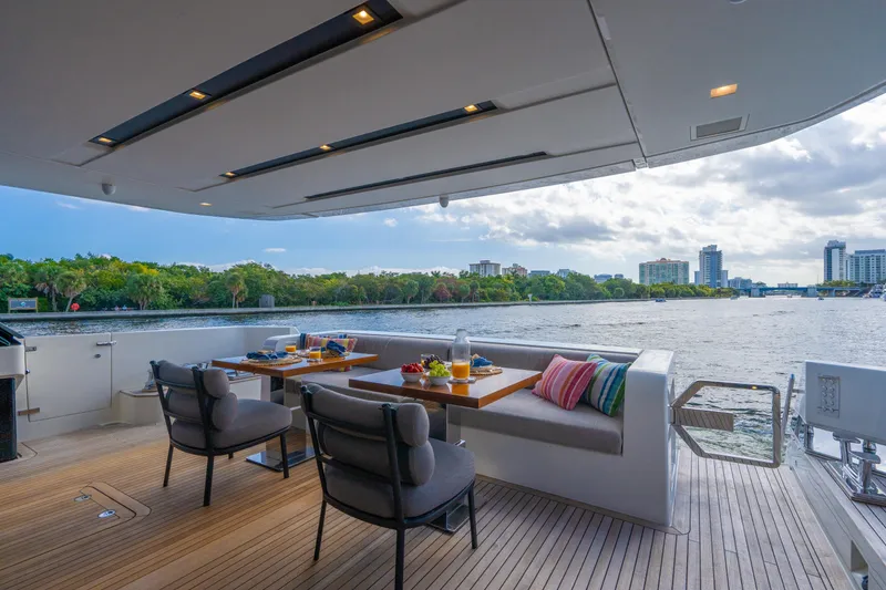 Slide: The Image of Luxurious 2023 Sanlorenzo SL96A yacht deck with dining area overlooking scenic waterfront. - 42