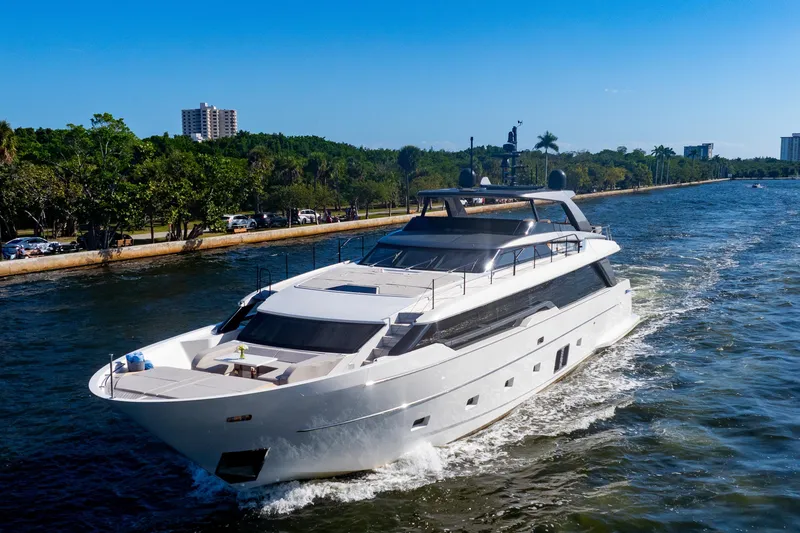 Slide: The Image of 2023 Sanlorenzo SL96A yacht cruising on a scenic waterway with lush greenery. - 50