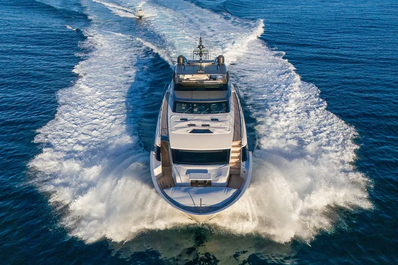 Slide: The Image of Luxurious 2023 Sanlorenzo SL96A yacht cruising on open sea, creating dynamic water trails. - 51