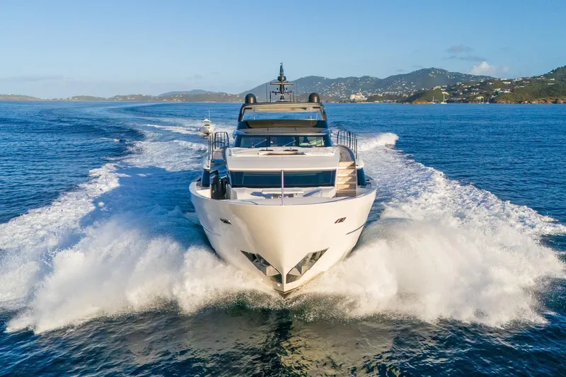 Slide: The Image of 2023 Sanlorenzo SL96A yacht cruising on open water with scenic coastal backdrop. - 57