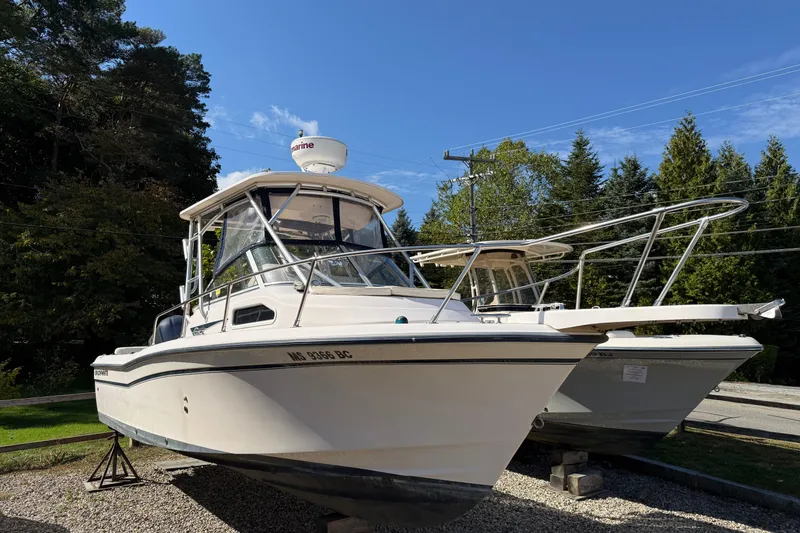 Slide: The Image of 2008 Grady-White Seafarer 228 boat on display, surrounded by trees and clear sky. - 0