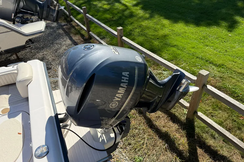 Slide: The Image of 2008 Grady-White Seafarer 228 with Yamaha outboard engine, parked near wooden fence. - 3
