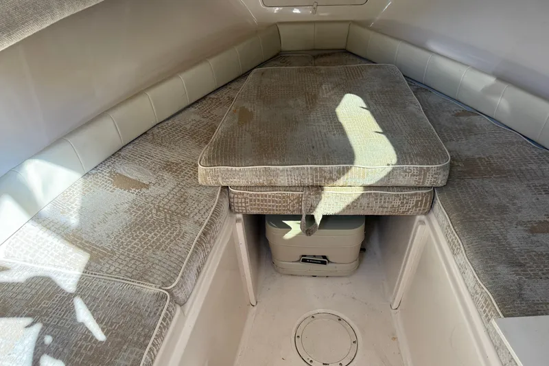 Slide: The Image of 2008 Grady-White Seafarer 228 cabin interior with cushioned seating and storage. - 7