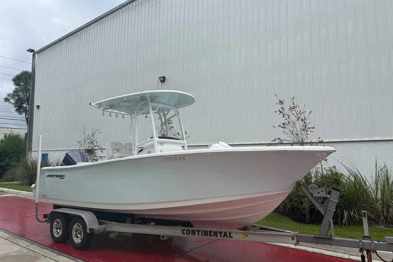 Slide: The Image of 2020 Sportsman Open 232 Center Console boat on trailer, parked outdoors. - 0