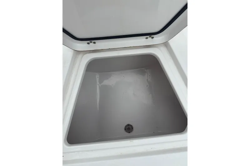 Slide: The Image of Open storage compartment on 2020 Sportsman Open 232 Center Console boat. - 12