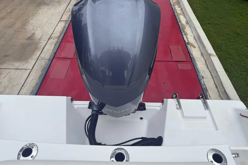 Slide: The Image of 2020 Sportsman Open 232 Center Console boat engine on red trailer. - 15