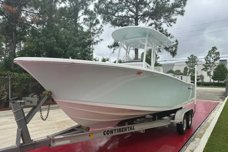 Slide: The Image of 2020 Sportsman Open 232 Center Console boat on trailer, parked outdoors. - 17