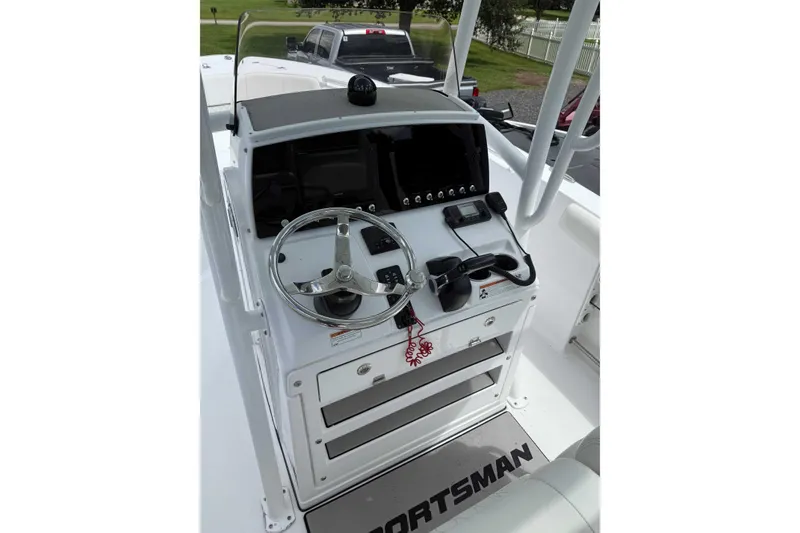 Slide: The Image of 2020 Sportsman Open 232 Center Console boat dashboard with steering wheel and controls. - 3