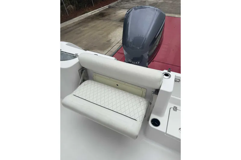 Slide: The Image of 2020 Sportsman Open 232 Center Console boat with cushioned seating and powerful outboard motor. - 8