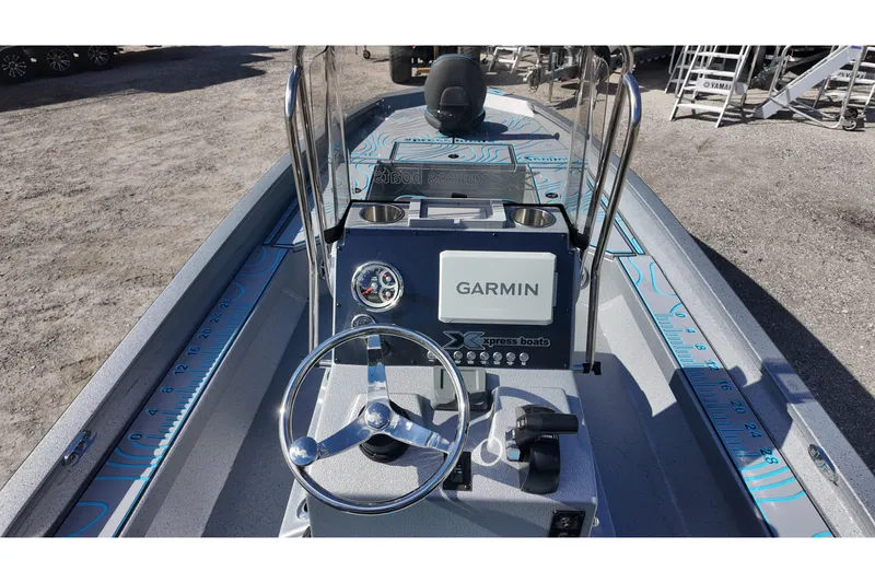 Slide: The Image of 2026 Xpress H24B Bay boat interior with Garmin navigation system and steering wheel. - 17