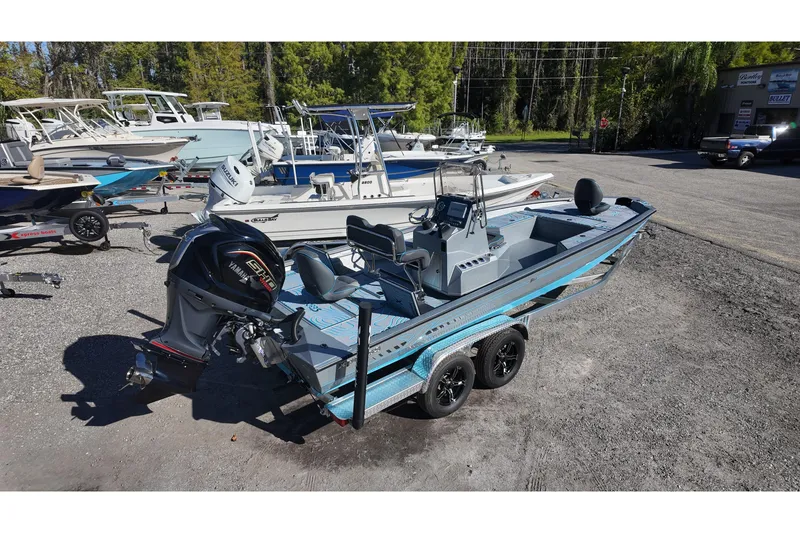 Slide: The Image of 2026 Xpress H24B Bay boat with Yamaha engine on trailer in a marina. - 5