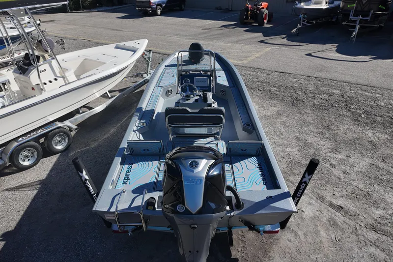Slide: The Image of 2026 Xpress H24B Bay boat with Yamaha engine, parked outdoors. - 8