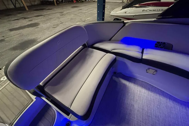 Slide: The Image of 2021 Crownline 290 SS boat stored on a rack in a warehouse. - 10