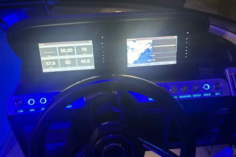 Slide: The Image of Dashboard of a 2021 Crownline 290 SS boat with illuminated controls and digital displays. - 14