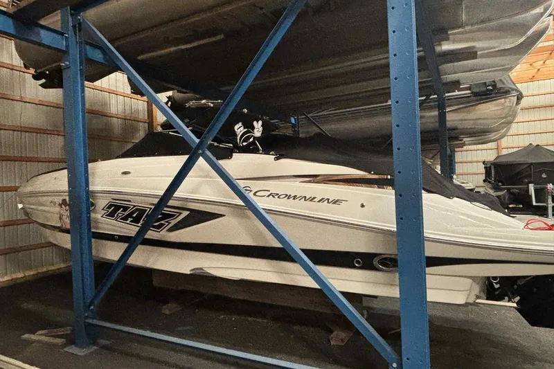 Slide: The Image of 2021 Crownline 290 SS boat interior with sleek seating and modern dashboard. - 5