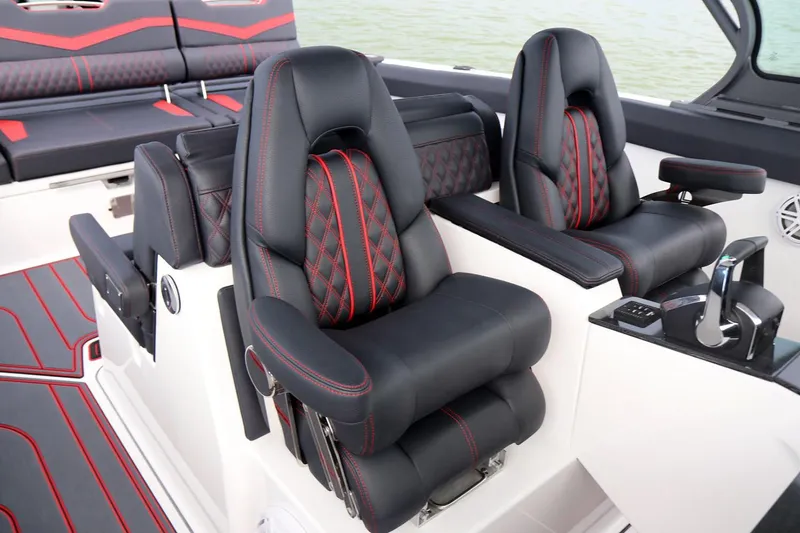Slide: The Image of 2026 Monterey Elite 30 OB boat interior with luxurious seating in a showroom. - 8