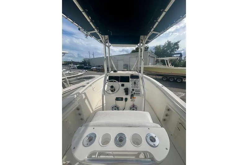 Slide: The Image of 2006 Triton 225 CC boat interior with steering console and seating. - 5