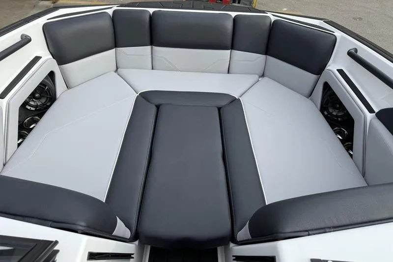 Slide: The Image of 2025 Moomba Max boat interior with black and gray cushioned seating. - 10