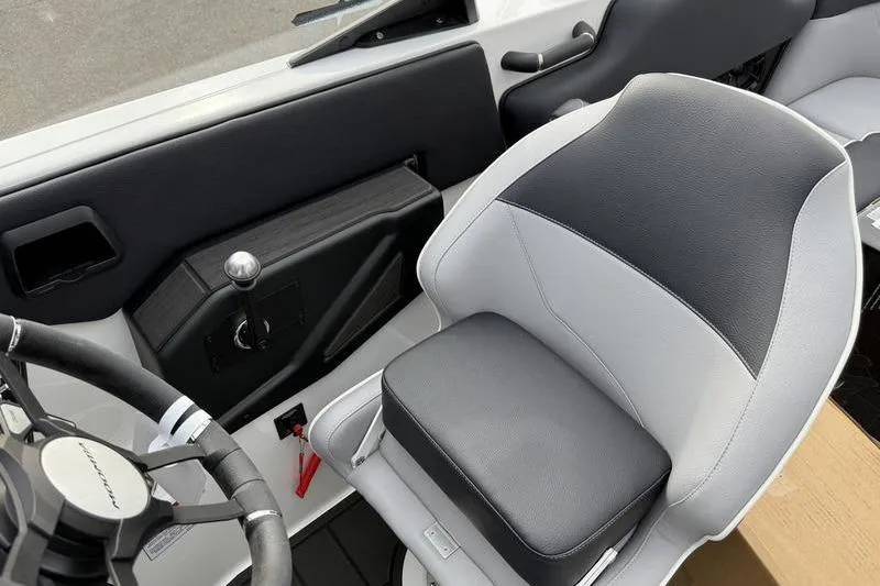 Slide: The Image of 2025 Moomba Max boat interior with steering wheel and cushioned seat. - 6