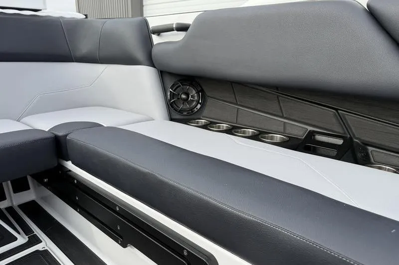 Slide: The Image of 2025 Moomba Max interior with sleek seating, cup holders, and speaker system. - 8