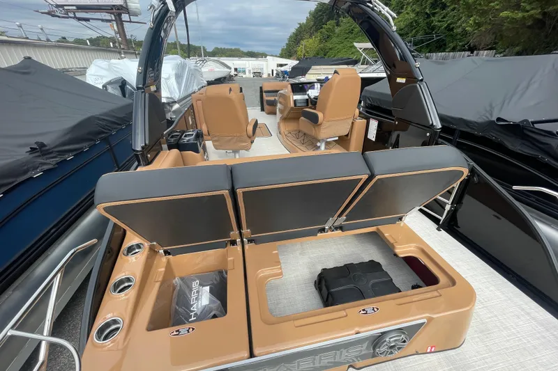 Slide: The Image of 2026 Harris Grand Mariner 250 boat interior with open storage compartments and seating. - 12