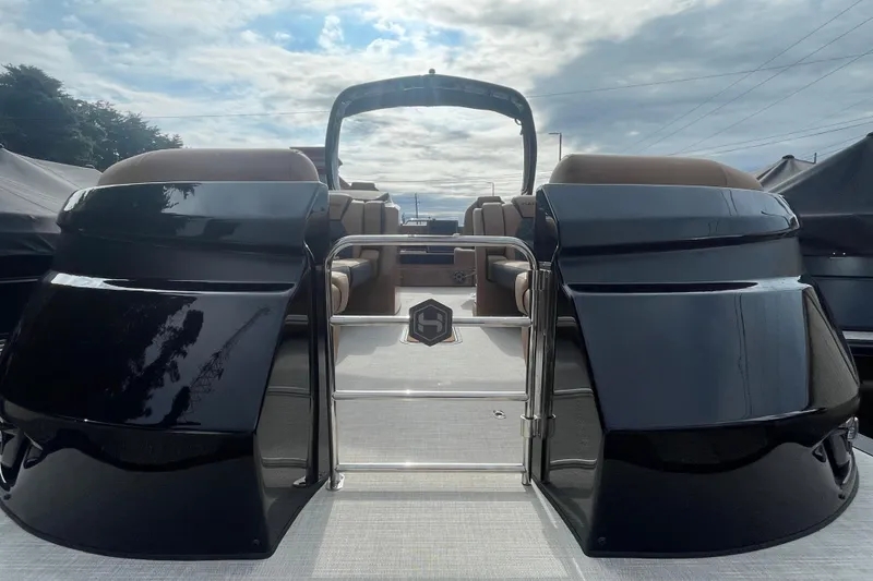 Slide: The Image of 2026 Harris Grand Mariner 250 pontoon boat with sleek black exterior and luxurious seating. - 2