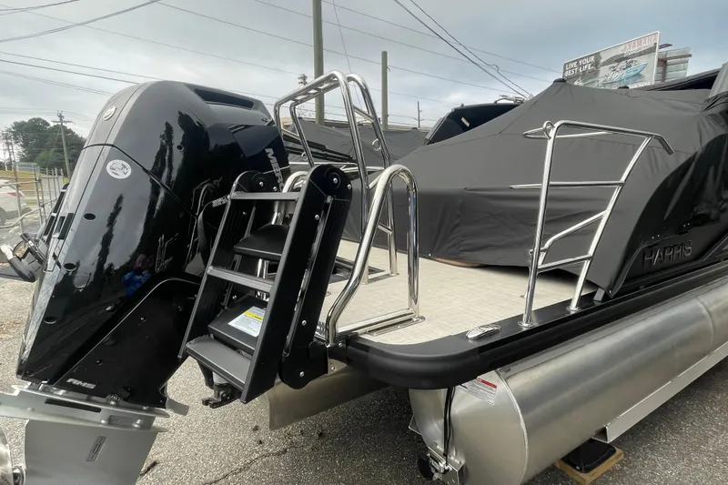 Slide: The Image of 2026 Harris Grand Mariner 250 pontoon boat with powerful outboard motor and sleek design. - 21