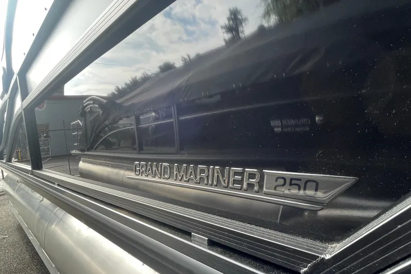 Slide: The Image of 2026 Harris Grand Mariner 250 boat with sleek metallic design and logo detail. - 3