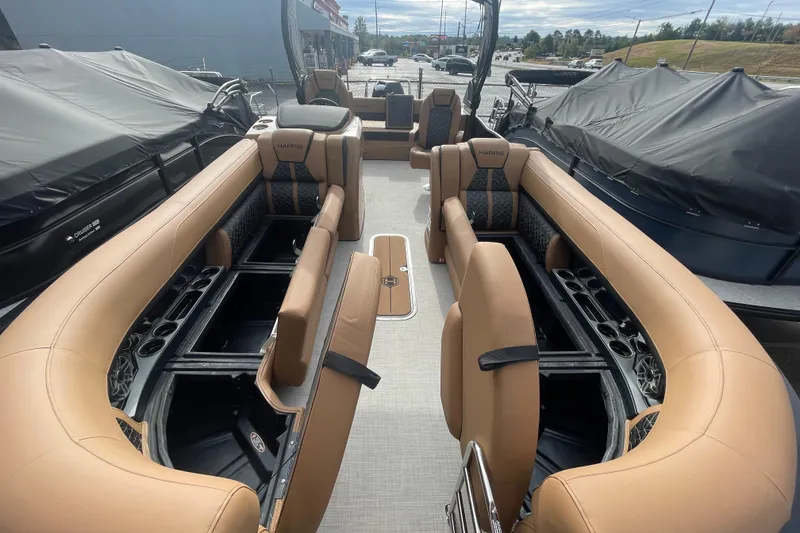 Slide: The Image of 2026 Harris Grand Mariner 250 pontoon boat interior with luxurious tan seating and storage compartments. - 4