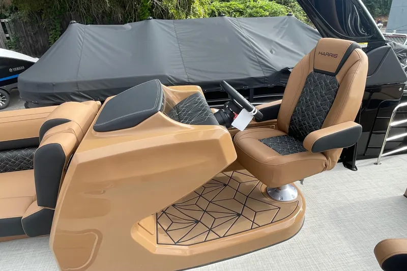 Slide: The Image of 2026 Harris Grand Mariner 250 boat interior with luxurious tan and black seating. - 5
