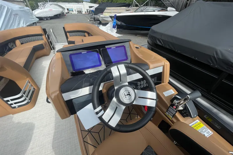 Slide: The Image of 2026 Harris Grand Mariner 250 boat interior with modern dashboard and dual screens. - 6