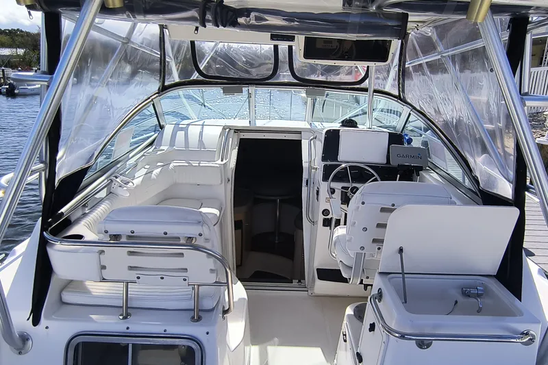Slide: The Image of Interior view of 2002 Boston Whaler 295 Conquest boat with helm and seating area. - 10