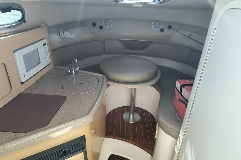 Slide: The Image of Interior of 2002 Boston Whaler 295 Conquest boat with kitchenette and seating area. - 11
