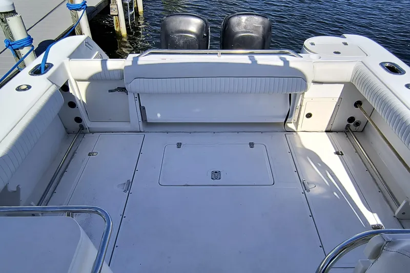 Slide: The Image of 2002 Boston Whaler 295 Conquest boat deck with seating and twin engines. - 4
