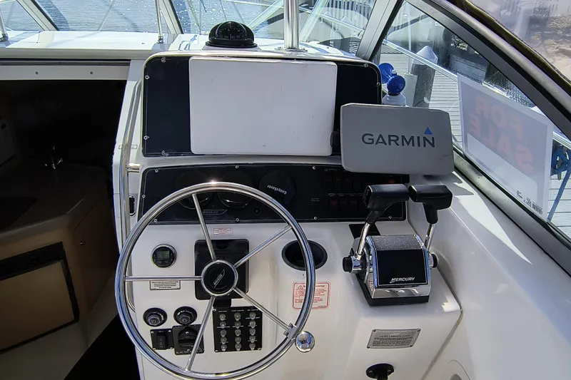 Slide: The Image of 2002 Boston Whaler 295 Conquest helm with Garmin navigation and Mercury controls. - 5