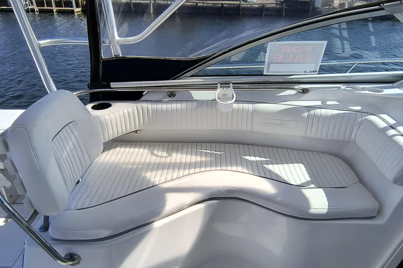 Slide: The Image of 2002 Boston Whaler 295 Conquest boat interior with white seating and "For Sale" sign. - 7
