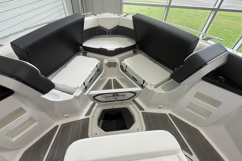 Slide: The Image of Luxurious seating area on the 2026 Monterey Elite 30 OB boat, featuring modern design and storage. - 10
