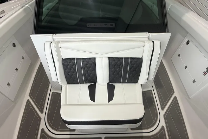 Slide: The Image of Luxury seating on 2026 Monterey Elite 30 OB boat, featuring elegant white and black upholstery. - 11