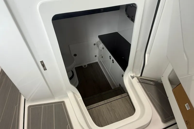 Slide: The Image of Interior view of 2026 Monterey Elite 30 OB boat cabin with modern amenities. - 12