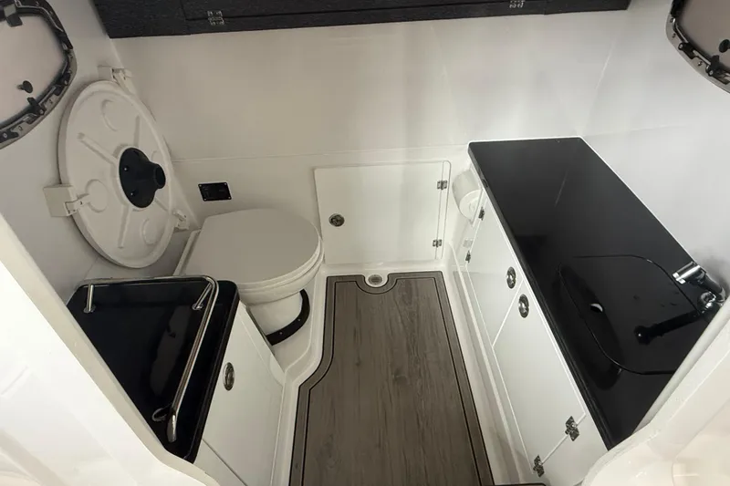 Slide: The Image of Luxurious bathroom interior of 2026 Monterey Elite 30 OB boat, featuring modern fixtures and sleek design. - 13