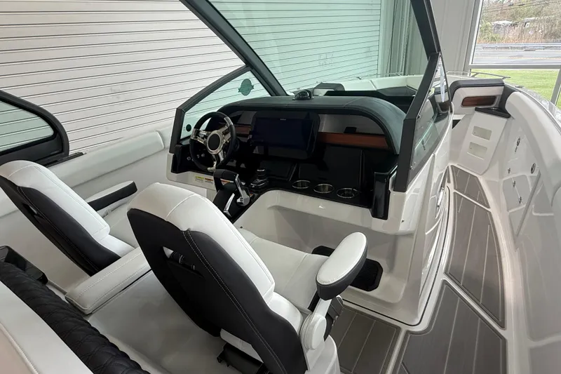 Slide: The Image of Interior of 2026 Monterey Elite 30 OB boat with modern helm and seating. - 17
