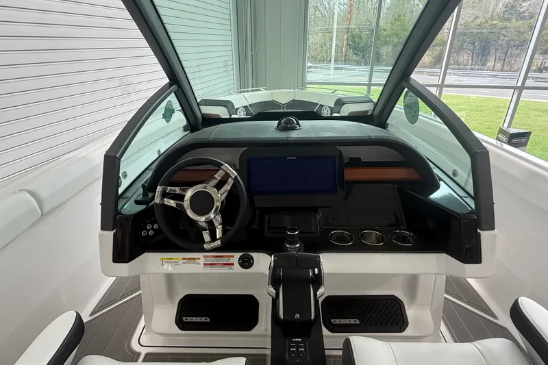 Slide: The Image of 2026 Monterey Elite 30 OB boat cockpit with modern steering and dashboard controls. - 18