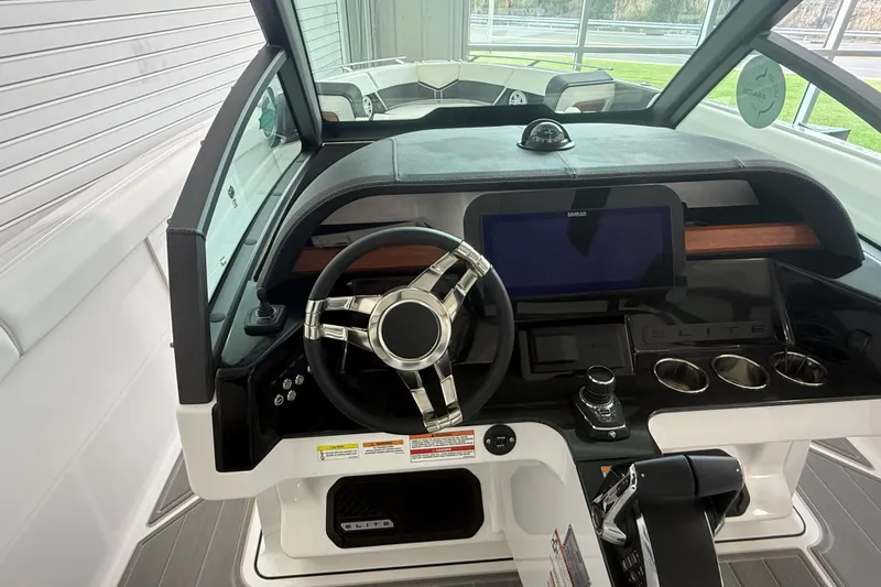 Slide: The Image of Cockpit of 2026 Monterey Elite 30 OB boat with modern steering and controls. - 19