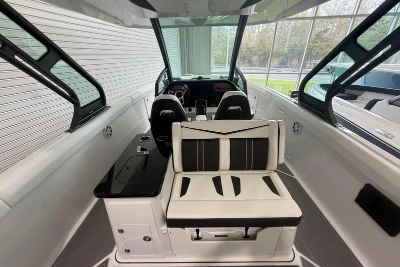 Slide: The Image of Interior view of 2026 Monterey Elite 30 OB boat with modern seating and dashboard. - 20