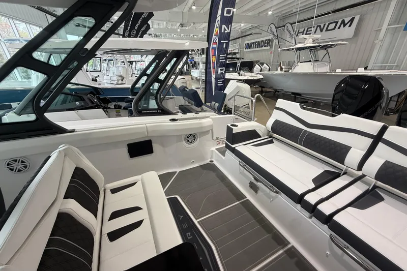 Slide: The Image of 2026 Monterey Elite 30 OB boat interior with sleek seating and modern design in showroom. - 21