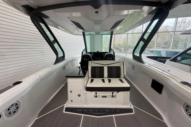 Slide: The Image of 2026 Monterey Elite 30 OB boat interior with sleek seating and modern design. - 24