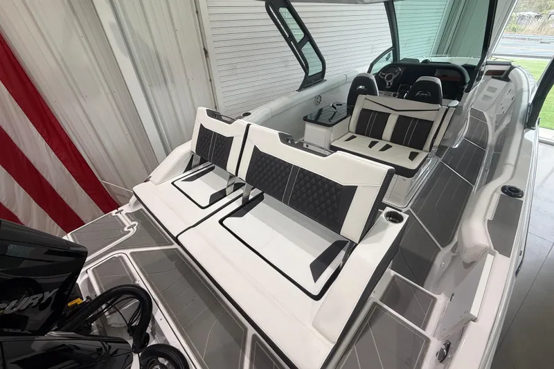 Slide: The Image of 2026 Monterey Elite 30 OB boat interior with sleek seating and modern design. - 26
