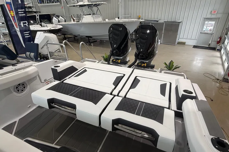 Slide: The Image of 2026 Monterey Elite 30 OB boat interior with dual Mercury engines in showroom. - 27